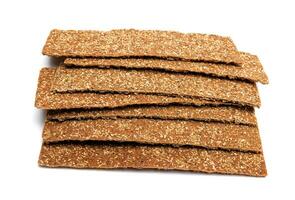 Slices of healthy low calories grain crisp bread for snack and crumbs on white background. photo