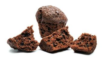 Whole and broken into pieces chocolate muffin isolated on a white background. Chocolate chip muffin. photo