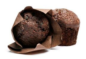 Two chocolate muffins isolated on a white background . Muffin with chocolate chips. photo