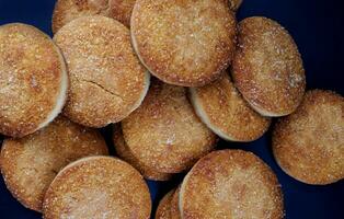 Beautiful round cookies on a black background. A few cookies. Cookies background. photo