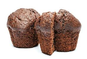 Whole and cut in half chocolate muffin isolated on white background. Chocolate chip muffin. photo