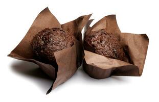 Two chocolate muffins isolated on a white background . Muffin with chocolate chips. photo