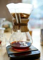 Coffee is brewed in a glass brewing vessel. photo