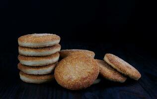 Beautiful round cookies on a black background. A few cookies. A bunch of cookies. photo