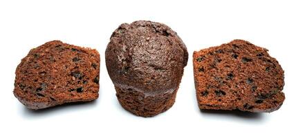 Whole and cut in half chocolate muffin isolated on white background. Chocolate chip muffin. photo