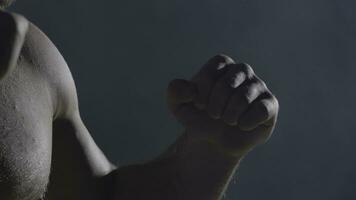 Punches close up in smoke dark background. Muscular kickbox or muay thai fighter punching in smoke. photo