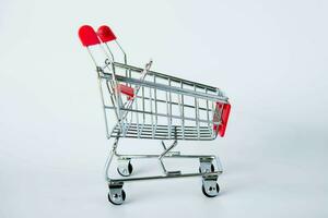 red shopping cart on white background photo