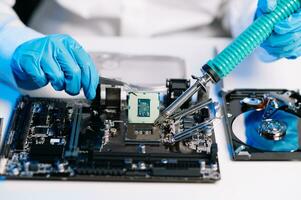 The technician is putting the CPU on the socket of the computer motherboard. electronic engineering electronic repair, electronics measuring and testing, repair photo