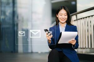 Woman hands using Laptop, tablet typing on keyboard and surfing the internet with email icon, email marketing concept, send e-mail or newsletter, online working photo