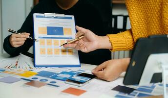 Close up view of UI developer team brainstorming on their project with laptop, smartphone and digital tablet. Creative digital development photo