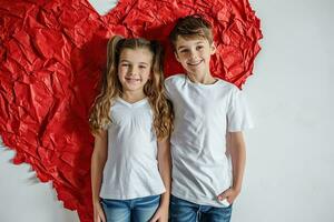 AI generated Kids in white t-shirts on a background of a heart. Kids t-shirts mockup. photo