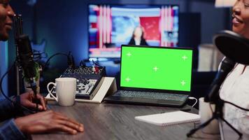 Isolated screen laptop next to analog mixer used by show host recording podcast in studio. Chroma key notebook near man professional audio device in live broadcast ensuring flawless sound quality video