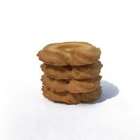 A pile of brownish-colored Cookies isolated on a white background. photo