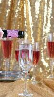 Champagne pouring into a glass on sparkling background video