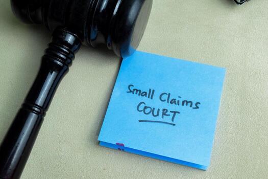 Concept of Small Claims Court write on sticky notes isolated on Wooden Table. photo