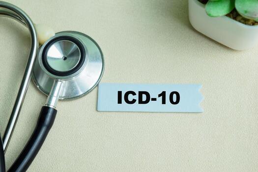 Concept of ICD-10 write on sticky notes with stethoscope isolated on Wooden Table. photo