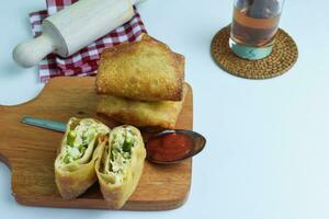 Indonesian traditional food - Martabak Tahu or Tofu Martabak, a spicy omelette pancake filled with bits of vegetables, leek, celery leaves, tofu and egg photo