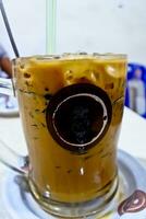 close-up view of a glass of iced cappuccino coffee photo