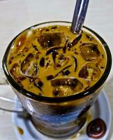 close-up view of a glass of iced cappuccino coffee photo