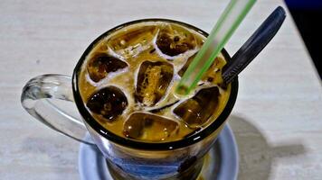 close-up view of a glass of iced cappuccino coffee photo