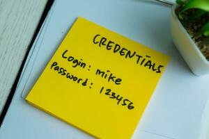 Concept of Credentials, Login and Password write on sticky notes isolated on Wooden Table. photo