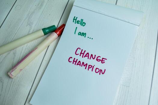 Concept of Hello I am.. Change Champion write on book isolated on Wooden Table. photo