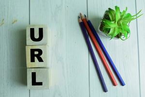 Concept of The wooden Cubes with the word URL on wooden background. photo