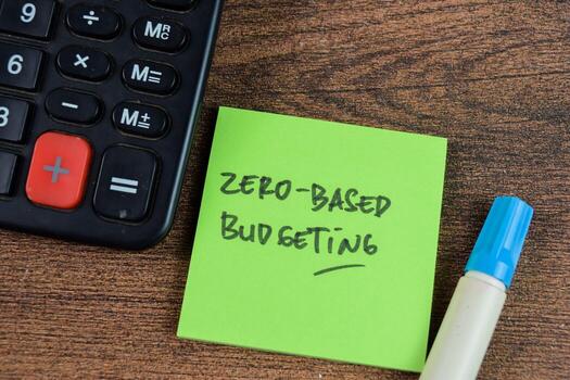 Concept of Zero-Based Budgeting write on sticky notes isolated on Wooden Table. photo