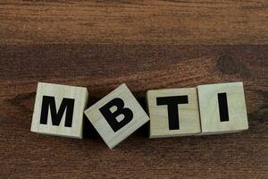 Concept of The wooden Cubes with the word MBTI on wooden background. photo