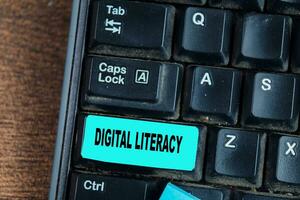 Concept of Digital Literacy write on keyboard isolated on laptop background photo