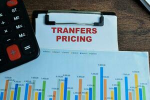 Concept of Transfers Pricing write on paperwork isolated on wooden background. photo