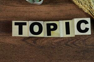 Concept of The wooden Cubes with the word Topic on wooden background. photo