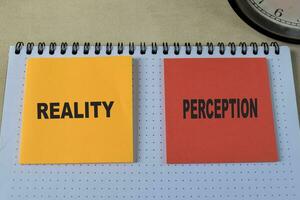 Concept of Reality or Perception write on book isolated on Wooden Table. photo