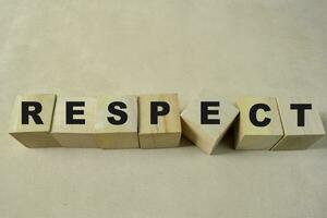 Concept of The wooden Cubes with the word Respect on wooden background. photo