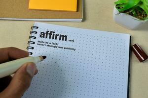 Definition of Affirm word with a meaning on a book. Dictionary concept photo