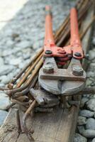 close up steel cutting pliers on home garden photo