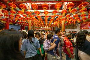 Atmosphere inside Wat Mangkon Kamalawat ,Leng Neey Yi. People come to worship and pray for blessings from in Wat Mangkon. Chinese New Year on Yaowarat Road photo