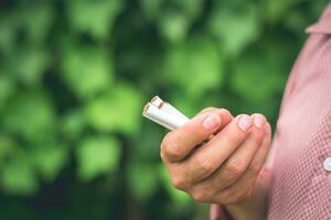 A smoker is holding some cigarette on the hand photo