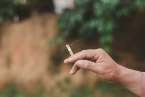 Hand holding cigarette photo