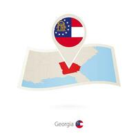 Folded paper map of Georgia U.S. State with flag pin of Georgia. vector