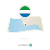 Folded paper map of Sierra Leone with flag pin of Sierra Leone. vector