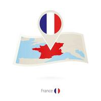 Folded paper map of France with flag pin of France. vector