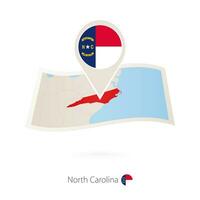 Folded paper map of North Carolina U.S. State with flag pin of North Carolina. vector