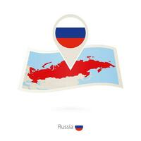 Folded paper map of Russia with flag pin of Russia. vector