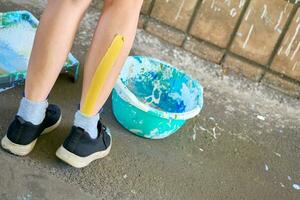 Female artist painter's leg taped with a plaster, patch photo