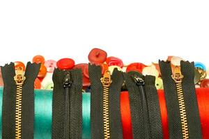 Black zippers for clothes,a spools of thread,buttons photo