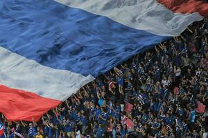 Bangkok, Thailand , 2014 - At a football game, the Thailand flag is flown in a stadium. photo