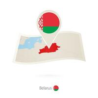 Folded paper map of Belarus with flag pin of Belarus. vector