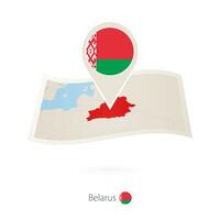 Folded paper map of Belarus with flag pin of Belarus. vector