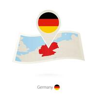Folded paper map of Germany with flag pin of Germany. vector